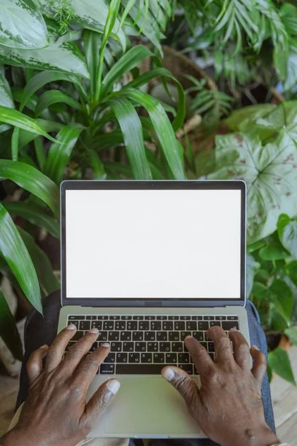 man-sitting-on-chair-using-silver-laptop-3wni-5s4lvg