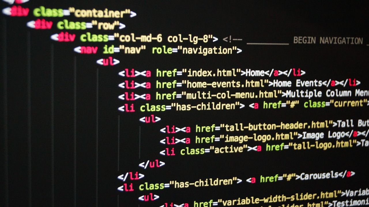 Close-up of colorful HTML code on a computer monitor, highlighting web development and programming.